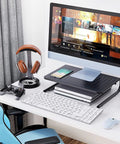 Desktop Monitor Stand With Dope Ventilated Perforated Steel Design supporting monitor on desk with keyboard and mouse