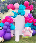 Doggo Approved Paw Print Party Balloon Kit with pink, teal, purple, hot pink paw print balloons and bone foil balloon display