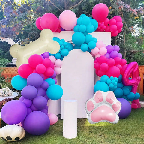 Doggo Approved Paw Print Party Balloon Kit with pink, teal, purple, hot pink paw print balloons and bone foil balloon display