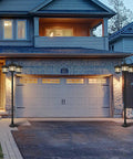 76 Inch Black Solar Lamp Post Light With Three Heads installed in front of a garage, illuminating driveway, durable cast aluminum