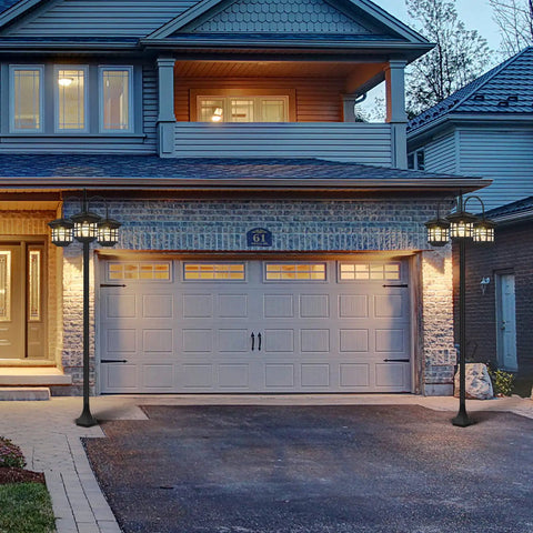 76 Inch Black Solar Lamp Post Light With Three Heads installed in front of a garage, illuminating driveway, durable cast aluminum