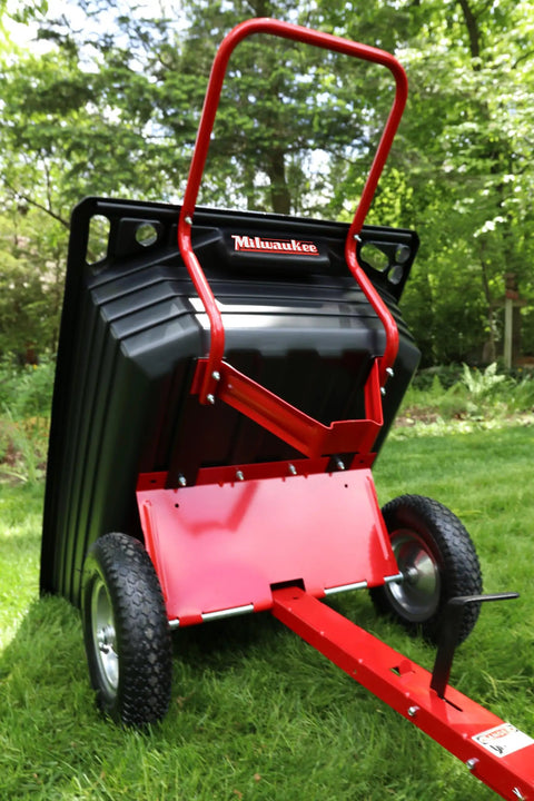 Rock Solid Six Hundred Fifty Pound Poly Dump Cart showing black bin, red frame, and pneumatic tire, ideal for yard debris hauling.