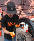 Mechanic applying Endurance Formula Tubeless Bike Tire Sealant With Injector For MTB Road CX And Gravel Bikes Eight Ounce Bottle