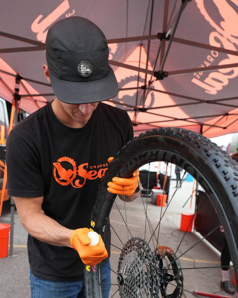 Mechanic applying Endurance Formula Tubeless Bike Tire Sealant With Injector For MTB Road CX And Gravel Bikes Eight Ounce Bottle