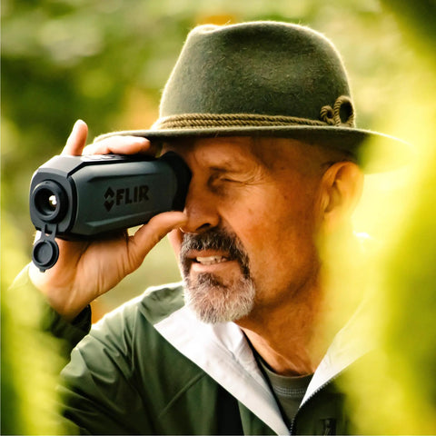 Man using Scion OTM 9Hz Thermal Imaging Monocular With Onboard Video Recording And MicroSD Expansion outdoors