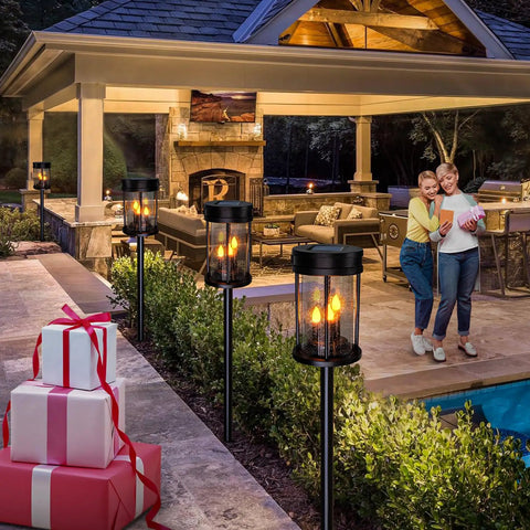 Outdoor Solar Stake Lights With Flickering Candle Lanterns For Yard And Patio 2 Pack Black Garden Pathway Lights Weatherproof 3 In 1 Design Easy Install Adds Warm Ambient Glow To Lawn Walkway Wall Decor illuminating a patio area