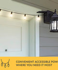 Traditional Outdoor Wall Sconce With Seeded Glass And Two Built In GFCI Outlets For Easy Access Power Black Finish Weather Resistant Porch Lighting For Patio Or Garden mounted on wall with string lights