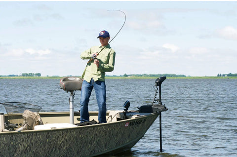 Angler using President Spincast Reel Size 10 With Dual Handle Positions Aluminum Spool And Dial Drag System Blue on a boat