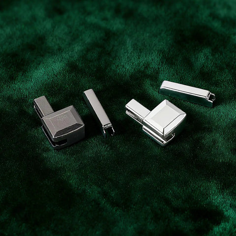 Zipper Repair Kit With Metal Insertion Pins, Slider Retainers, And Top And Bottom Stops on green fabric
