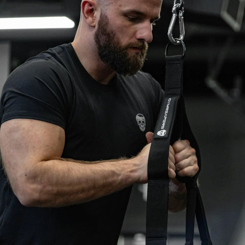 Man using Ultimate Tricep Rope Attachment With Built In Three Lengths, Multi Grip Cable in gym, close-up view.