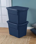 No Sweat 18 Gallon Plastic Storage Totes With Secure Snap Lids 32 Pack stacked navy bins on wood floor for organizing.
