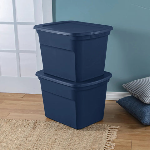 No Sweat 18 Gallon Plastic Storage Totes With Secure Snap Lids 32 Pack stacked navy bins on wood floor for organizing.