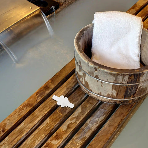 Sauna Steamer Connector Hose Joint Durable Plastic Replacement Fitting on wooden surface near spa bucket and flowing water