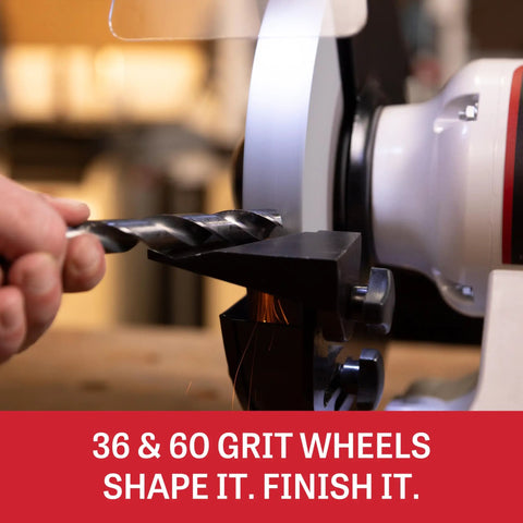 Eight Inch Bench Grinder With Integrated Led Work Lights And Built In Coolant Tray Powered By One Half Hp Motor Delivering Three Thousand Four Hundred Fifty Rpm For Heavy Duty Grinding And Top Shelf Tool Sharpening On Your Workbench sharpening a drill bit on a 36 grit wheel.