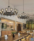 Kick Some Serious Style With This Built Tough Industrial Pendant Light Fixture For Restaurants And Modern Homes Featuring Rock Solid Durability And A Slick Energy Saving Glow in a restaurant with wooden seating and bar.