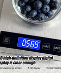 Digital Kitchen Scale For Home Chefs With 33Lb Capacity, Precise 1g/0.1oz Weighing, LCD Display Showing Blueberries In Bowl