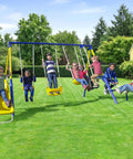 Kids playing on the Ultimate Backyard Swing Set With 5 Ft Wave Slide, Two Swings, Glider, Teeter Totter, Standing Swing, 6.1 Ft Steel Frame