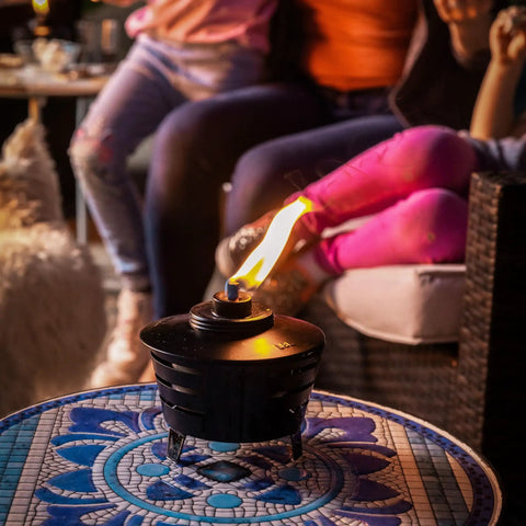 Mini Fire Pit Tabletop Torch Set Two Pack for Patio Backyard and Garden Black Metal Flame Torches With Long Lasting Wick and Snuffer on decorative table