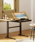 Flexispot Electric Drafting Table With Adjustable Height And Tilting Top 47.2 By 23.6 Inches Extendable Workstation Storage Drawer shown in art studio setup.