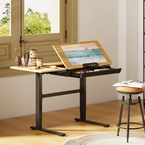 Flexispot Electric Drafting Table With Adjustable Height And Tilting Top 47.2 By 23.6 Inches Extendable Workstation Storage Drawer shown in art studio setup.