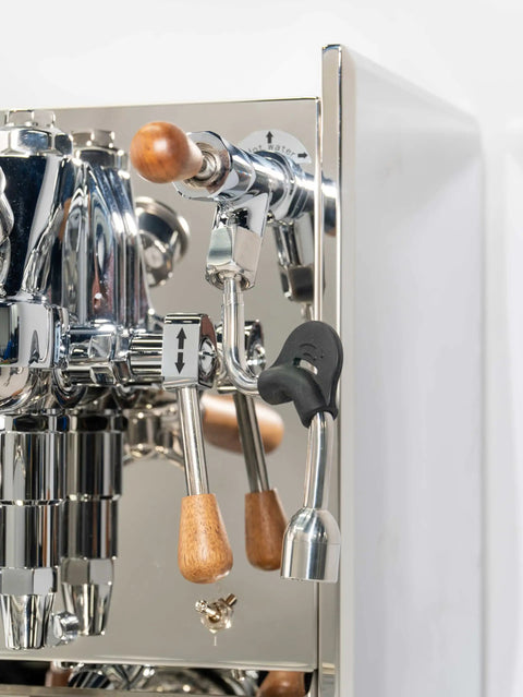 Close-up of Pro Grade Dual Boiler Espresso Maker With PID Precision Tuning, featuring chrome levers and wood handles.