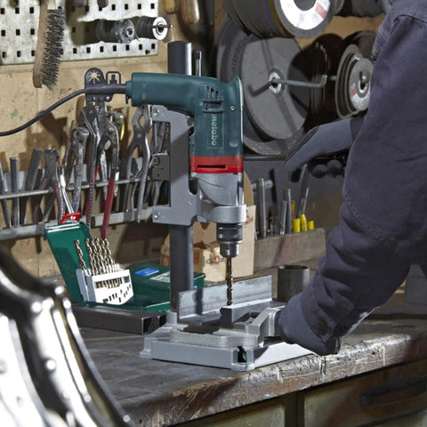 Heavy Duty One Half Inch High Torque Drill With Solid Six Point Seven Amp Motor And Wide Speed Range From Zero To Six Hundred Fifty Rpm in use on workshop table.