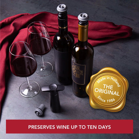 Two wine bottles with gray vacuum stoppers from Six Pack Vacuum Wine Stoppers Set For Open Bottles, No-Fuss Reusable Rubber Cork Alternatives That Create Airtight Seals With Wine Saver Pump, Keeps Wine Fresh Up To 10 Days, Gray with gold seal, red cloth and wine glasses in background.