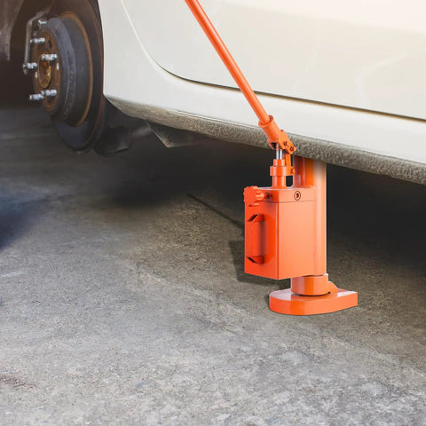 Heavy Duty Hydraulic Toe Jack 10 Ton Lift Capacity positioned under a car wheel for easy vehicle lifting in garages.