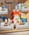 Sleek Two Tier Pull Out Under Sink Organizer For Kitchen Cabinets, Ultra Smooth Glide Storage Rack With Anti Tip Stops, Keeps Bottles Sponges And Cleaning Gear Shipshape And Ready When You Need It Quick, holding various cleaning supplies.