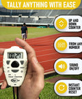 Slick Digital Tally Counter With Up And Down Clicker For Golf Laps Knitting And Crowd Counting Hella Fast Reset in a hand on a track.