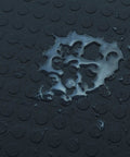 Close-up of water-resistant surface on interlocking 18 by 18 inch raised coin floor tile for home gym garage basement.