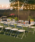 White Plastic Folding Chairs 2 Pack For Indoor And Outdoor Use 350 Pound Capacity Lightweight next to festively set tables