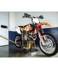 4000 Lb 3 In 1 Garage Floor Jack With Tie Down Straps lifting a motorcycle in a garage setting, demonstrating heavy duty use.