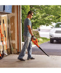 Person using Cordless Leaf Blower With Battery And Charger, 20V Max, 130 MPH Air Speed, Ultralight 3.7 Lb Design in garage