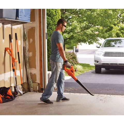 Person using Cordless Leaf Blower With Battery And Charger, 20V Max, 130 MPH Air Speed, Ultralight 3.7 Lb Design in garage