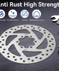 140mm Stainless Disc Brake Rotor With 6 Bolt Mount For Bikes And Electric Scooters on dark surface with wrench