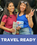Front view: blue BAND-AID Travel Ready First Aid Kit (80 pieces) held by two women, with a gray water bottle.