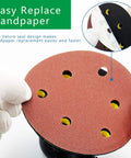 Hands holding sandpaper for Dual Action Pneumatic Sander With Vacuum Extraction, 5 Inch And 6 Inch Pads self vacuum dust removal.