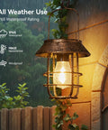 Two Pack Solar Lanterns Outdoor Waterproof Hanging Lights With Wall Hooks Retro Metal Lanterns in rain showing weatherproof design