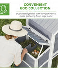 Person accessing eggs in 66.5 Inch Large Wooden Chicken Coop With 2 Nesting Boxes, Ramp, Sliding Tray And Waterproof Roof, Outdoor Hen House For Backyard Farms, Ideal For 2 To 4 Hens