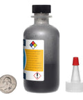 Molybdenum Disulfide MoS2 1 Ounce Bottle 99 Percent Pure Reagent Grade 1.5 Micron Powder For Lubrication Industrial Lab Use with cap and quarter for scale.