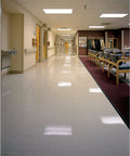 Clean hospital hallway showcasing polished floors cleaned with Low Speed Stripper Floor Pad 19 Inch Black For Heavy Duty Concrete Cleaning