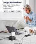 4-Outlet 4-USB Surge Protector With 5 Ft Extension Cord 900 Joules Overload Switch on white carpet with laptop and phone