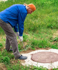 Man using 2 Pack Heavy Duty Manhole Cover Hook Lifter T Shaped Stainless Steel Manhole Lifting Hooks Workhorse on ground