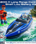 Boy playing with two pack 10 inch remote control boat for pools and salt water fast 15 KPH dual speed RC boats while smiling.