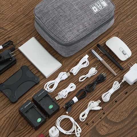 Hella Organized Travel Case For Small Electronics And Usb Charging Gear Including Phone Cables Mouse Sd Cards Power Bank Earphone Bag shown with assorted gadgets and cables on wooden surface.