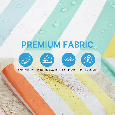 Close-up of waterproof beach tote fabric showing rainbow stripes, water droplets, sandproof and lightweight features, sand on fabric.