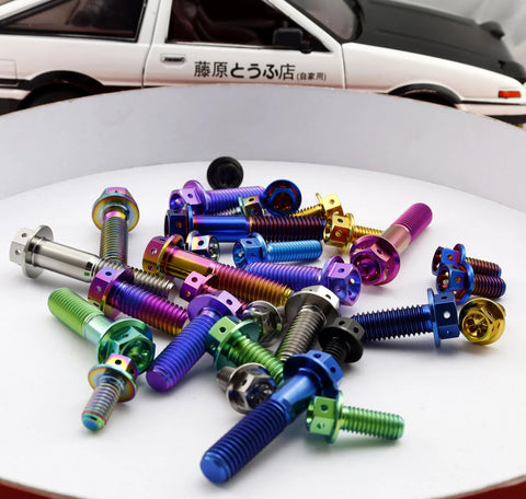 Assorted burnt-blue titanium bolts with flange and hex heads, M6x12mm, colorful finishes scattered on white surface.