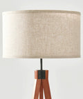 Close-up of Havana Brown Mid Century Tripod Floor Lamp With Dimmable LED showing beige fabric drum shade and solid wood legs.