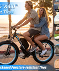 Badass 9000W Dual Motor Electric Bike For Adults with 26"x4.0" fat tires on a sunset beach road.